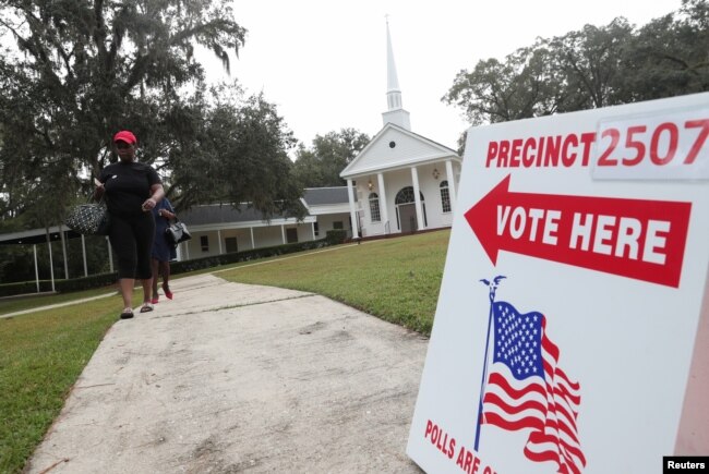 Voters leave a polling station during the midterm election in Tallahassee, Florida, Nov. 6, 2018.