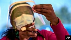 In this May 25, 2021, file photo, a health worker prepares a dose of the Pfizer coronavirus vaccine at the Orange Farm Clinic near Johannesburg. In the global race to vaccinate people against COVID-19, Africa is tragically at the back of the pack. (AP Photo)