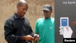 Cell phones are serving as a bank in your pocket, providing virtual accounts for South Africans excluded from the financial mainstream, Johannesburg's Soweto township, October 19, 2005.