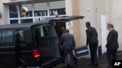 Two men carry suitcases containing the flight recorders from the Ethiopian jet, into the French air accident investigation authority, Thursday, March 14, 2019 Le Bourget, north of Paris. (AP Photo/Christophe Ena)