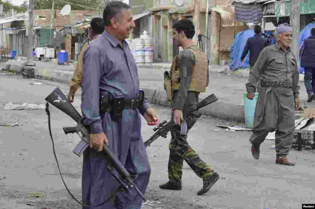 Kurdish fighters guard the Iraqi town of Qara Tappa, north of Baghdad, Oct. 21, 2014. 