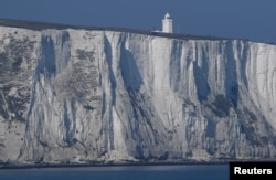 FILE - South Foreland lighthouse and the white cliffs of Dover are seen from a cross-channel ferry between Dover in Britain and Calais in France, March 27, 2017.