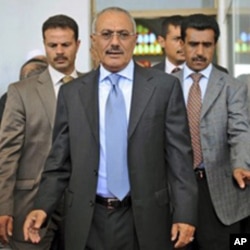 Yemeni President Ali Abdullah Saleh, center, flanked by body guards in Sana'a, March 10, 2011