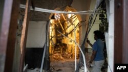 FILE - A Sri Lankan man uses his mobile phone to take pictures inside St. Anthony's Shrine in Colombo on April 26, 2019, following a series of bomb blasts targeting churches and luxury hotels on Easter Sunday in Sri Lanka.