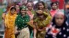 Bangladeshi garment workers arrive for work early morning in Dhaka, Bangladesh, Sept. 12, 2012. 