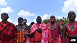 FILE—Cultural performers from the Maasai tribe sing at their manyatta (village) in Talek in the Maasai Mara National Reserve, where their work of performing for visiting tourists has dwindled, in Talek in Maasai Mara, in the Narok county in Kenya, on June 24, 2020. 