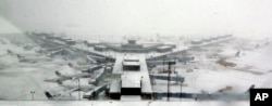 Airplanes stand in the snow at O'Hare International Airport, Feb. 1, 2015, in Chicago.