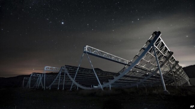  This November 2016 photo provided by the Canadian Hydrogen Intensity Mapping Experiment collaboration shows the CHIME radio telescope at the Dominion Radio Astrophysical Observatory in Kaleden, British Columbia, Canada. (Andre Renard/University of Toronto via AP)