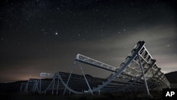 This November 2016 photo provided by the Canadian Hydrogen Intensity Mapping Experiment collaboration shows the CHIME radio telescope at Dominion Radio Astrophysical Observatory in Kaleden, British Columbia, Canada.  (Andre Renard / University of Toront