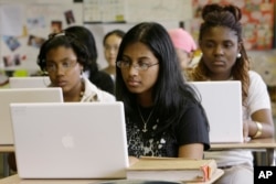 FILE - Ninth-graders work on laptop computers during a class at the Philadelphia High School for Girls in Philadelphia.
