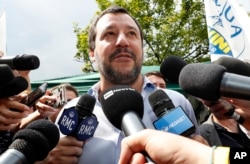 FILE - The League party leader, Matteo Salvini, meets reporters in Milan, Italy, May 19, 2018.