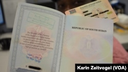 A national ID, shown behind this South Sudanese passport, is required for getting a job or applying to university in South Sudan.