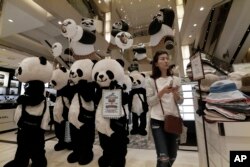 Workers wearing panda costumes attend a promotion event for Chinese tourists at a department store in Seoul, South Korea, Thursday, April 28, 2016.