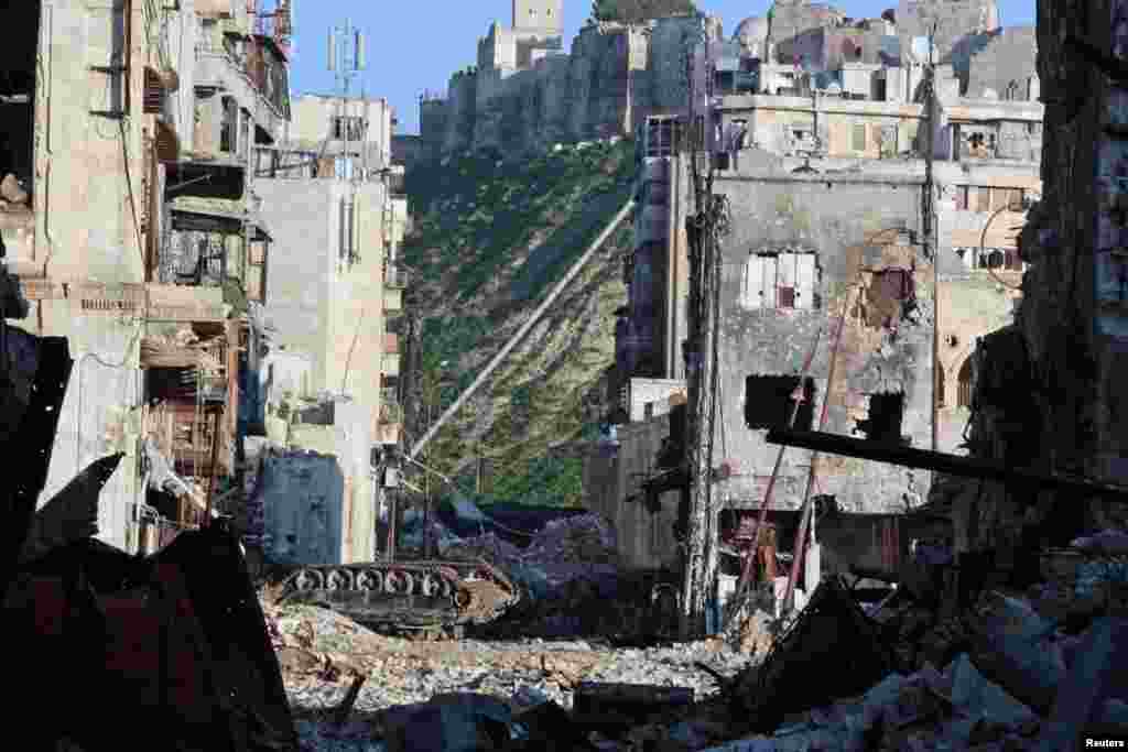 An overturned tank is seen in a damaged Khan Wazir street, which faces Aleppo's historic citadel controlled by forces loyal to Syria's President Bashar al-Assad, in Old Aleppo, Syria.