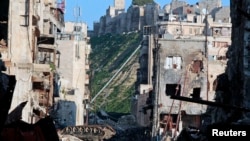 An overturned tank is seen in a damaged Khan Wazir street, which faces Aleppo's historic citadel controlled by forces loyal to Syria's President Bashar al-Assad, in Old Aleppo, Syria.