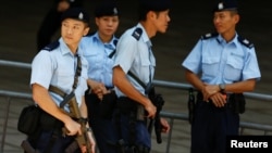 Armed policemen secure the area around the hotel where Chinese President Xi Jinping will stay in Hong Kong, June 29, 2017.