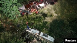 A damaged bus coach is seen after a crash near the southern town of Avellino, Italy, July 29, 2013.