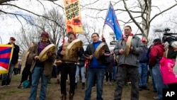 America Indians and their supporters protest outside of the White House, Friday, March 10, 2017, in Washington, to rally against the construction of the disputed Dakota Access oil pipeline. 