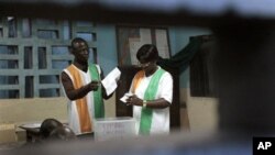 Election officials start counting ballots in the first round of presidential elections in Abidjan, Ivory Coast, Sunday Oct. 31, 2010.
