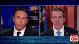 Chris Cuomo (L) interviews his brother, Governor Mario Cuomo of New York, on his CNN news program.