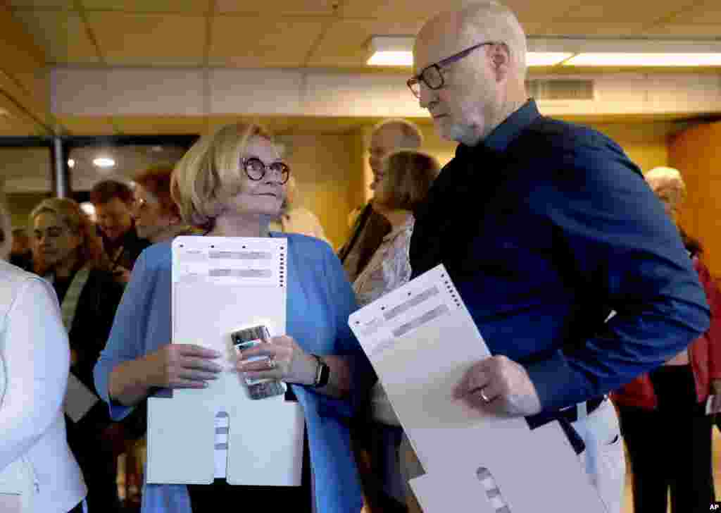 Incumbent Sen. Claire McCaskill, D-Mo., talks with her husband, Joseph Shepard, right, as they stand in line to vote Nov. 6, 2018, in Kirkwood, Mo. 
