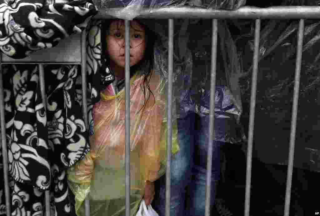 A migrant girl waits to register with the police at a refugee center in the southern Serbian town of Presevo. Several Eastern European countries are cooperating on controlling the flow of migrants at the external borders of the European Union &mdash; a program a top Hungarian official said could set an example for the rest of the 28-nation bloc.