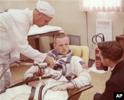 FILE - In this March 9, 1966 file photo, astronaut Neil Armstrong is seated during a suiting up exercise Cape Kennedy, Fla., in preparation for the Gemini 8 flight.