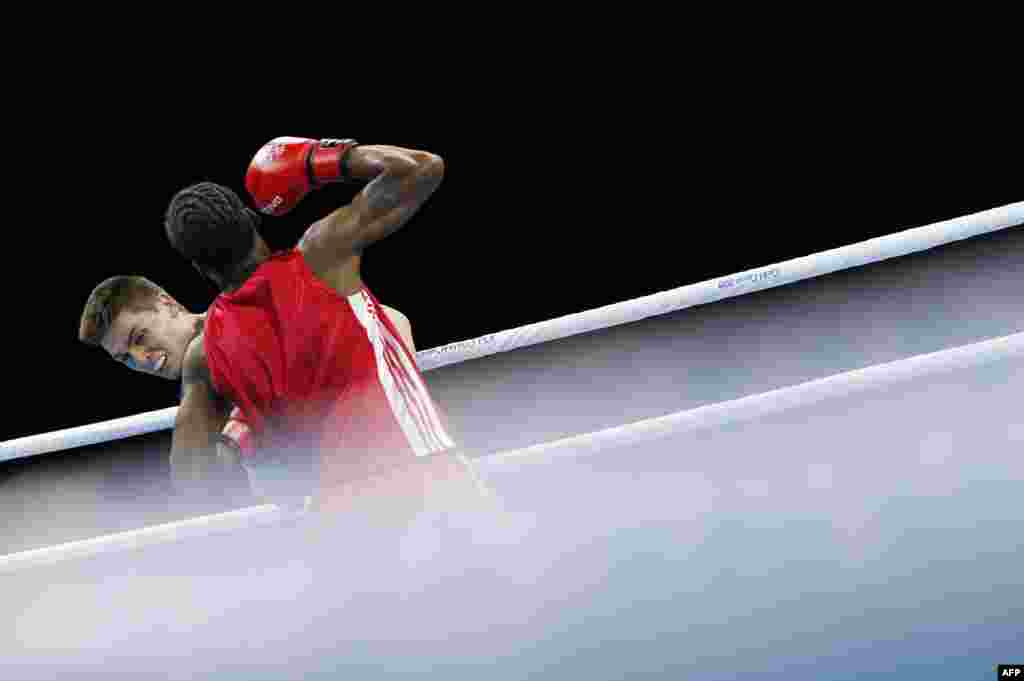 Grenada's Joshua Redhead (right) lands a punch against Australia's Campbell Somerville (left) during the men's middleweight (75kg) preliminary fight during the 2018 Gold Coast Commonwealth Games at Oxenford Studios venue in Gold Coast.