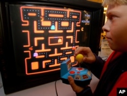 FILE - In this Oct. 5, 2004, photo, a youth tries a Ms. Pac-Man TV game in New York.