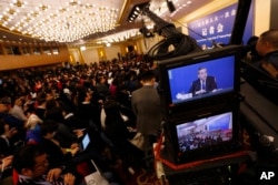 A camera screen shows China's Foreign Minister Wang Yi speaking during a press conference on the sidelines of the National People's Congress at the media center in Beijing, March 8, 2018.