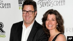 FILE - Musician Vince Gill and wife, singer Amy Grant, attend the Revlon Concert for the Rainforest Fund dinner and auction at The Pierre Hotel in New York, April 3, 2012.