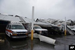 Rescue vehicles from the Emergency Management Agency stand trapped under an awning during the impact of Hurricane Maria, which hit the eastern region of the island, in Humacao, Puerto Rico, Sept. 20, 2017.