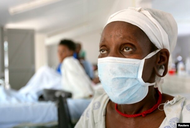 FILE - A patient who tested positive for extensively drug-resistant tuberculosis (XDR-TB) awaits treatment at a rural hospital in South Africa's impoverished KwaZulu-Natal province.