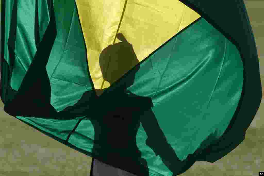 A soldier holds the Brazilian flag during the flag-raising ceremony at the Alvorada Palace, in Brasilia, Brazil.