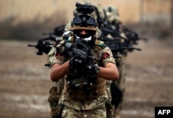FILE - Members of Iraq's Rapid Response military unit take part in counterterrorism training at a military base inside Baghdad International Airport, Dec. 4, 2018.