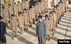 А YouTube screen grab from an undated Islamic State propaganda video shows child soldiers at an alleged IS training camp. Many of the children were reportedly taken from captured families and civilians living in formerly IS-controlled areas.