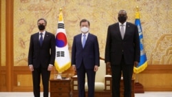 South Korean President Moon Jae-in, U.S. Defense Secretary Lloyd Austin and U.S. Secretary of State Antony Blinken pose for photographs during their meeting at the Presidential Blue House in Seoul, South Korea, March 18, 2021.