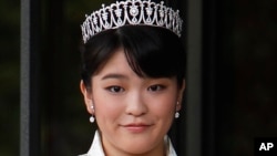 FILE - Japan's Princess Mako, the first daughter of Prince Akishino and Princess Kiko, poses for photos at Imperial Palace in Tokyo. Mako, the granddaughter of Emperor Akihito, is getting married to an ocean lover who can ski, play the violin and cook, according to public broadcaster NHK TV. The Imperial Household Agency declined to confirm the report Tuesday, May 16, 2017.