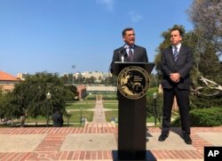 California Attorney General Xavier Becerra speaks at UCLA about his efforts to fight the Trump administration's proposal to weaken car efficiency fuel standards in Los Angeles, Aug. 2, 2018. Deputy Attorney General David Zaft is on the right.