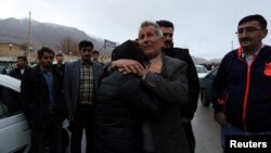 Relatives of a passenger who was believed to have been killed in a plane crash react near the town of Semirom, Iran, Feb. 18, 2017.