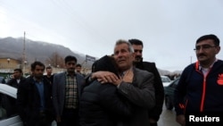 Relatives of a passenger who was believed to have been killed in a plane crash react near the town of Semirom, Iran, Feb. 18, 2017. (REUTERS/Tasnim News Agency)