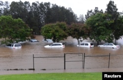 Cars sit submerged after heavy rain associated with Cyclone Debbie hit the Gold Coast suburb of Robina in Queensland, Australia, March 30, 2017.