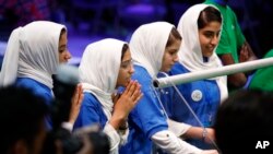 From left, Rodaba Noori, Somayeh Faruqi, Kawsar Roshan and Lida Azizi of Team Afghanistan encourage their robot during their final round of competition, at the FIRST Global Robotics Challenge, July 18, 2017, in Washington.