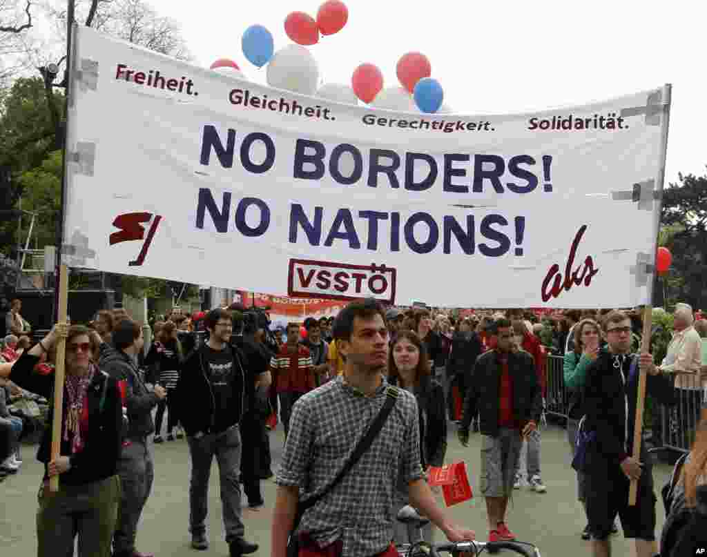 People carry a banner during a May Day celebration organized by the Austrian Social Democrats and trade unions, Vienna, Austria, May 1, 2013.