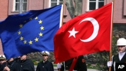 FILE - A Turkish guard of honor hold an EU flag and a Turkish flag in Ankara, Turkey, April 10, 2008.