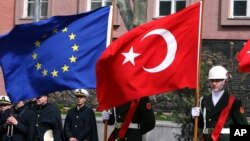 FILE - A Turkish guard of honor hold an EU flag and a Turkish flag in Ankara, Turkey, April 10, 2008.