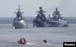 FILE - Russian war ships are seen anchored in a bay of the Russian fleet base in Baltiysk in Russia's Kaliningrad region between Poland and the Baltic states, July 19, 2015.
