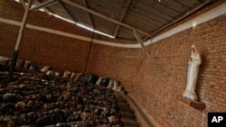 Piles of clothes belonging to some of those who were slaughtered as they sought refuge inside the church cover the pews as a memorial to the thousands who were killed during the 1994 genocide in and around the Catholic church in Nyamata, Rwanda, April 4, 2019.