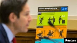 FILE - U.S. Centers for Disease Control and Prevention (CDC) Director Tom Frieden displays CDC educational materials as he testifies about the Ebola crisis in West Africa during a hearing of a House Foreign Affairs subcommittee on Capitol Hill in Washingt