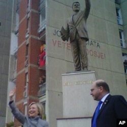 Hillary Clinton visiting the Bill Clinton statue in Pristina with US Ambassador to Kosovo Chrustopher Dell as a crowd of Kosovars cheer Clinton, 13 Oct 2010